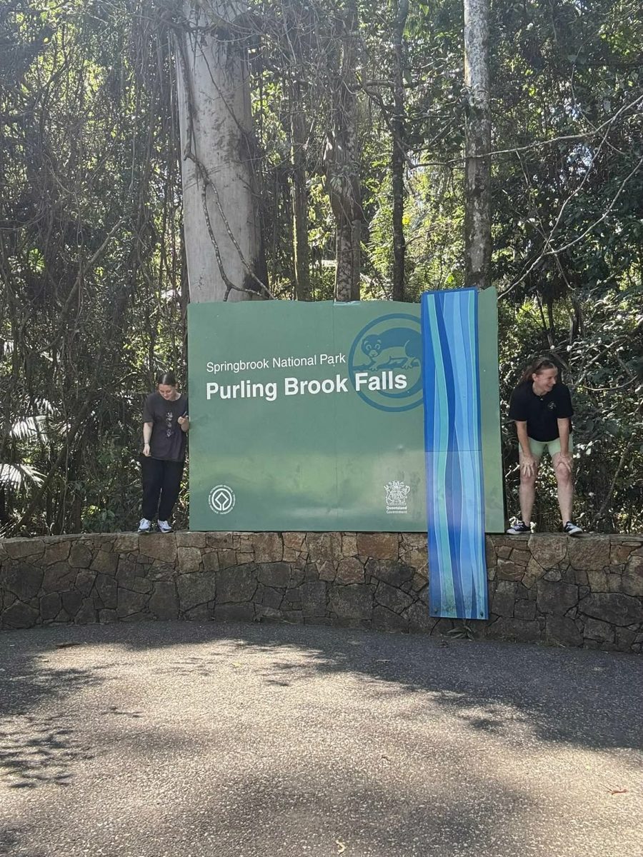 Participants at the Purling Brook Falls sign in Springbrook National Park