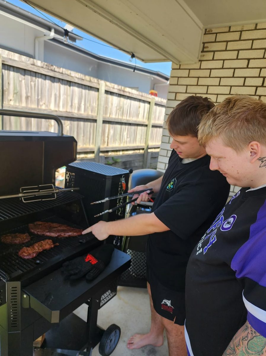 Two participants cooking on a barbecue at home