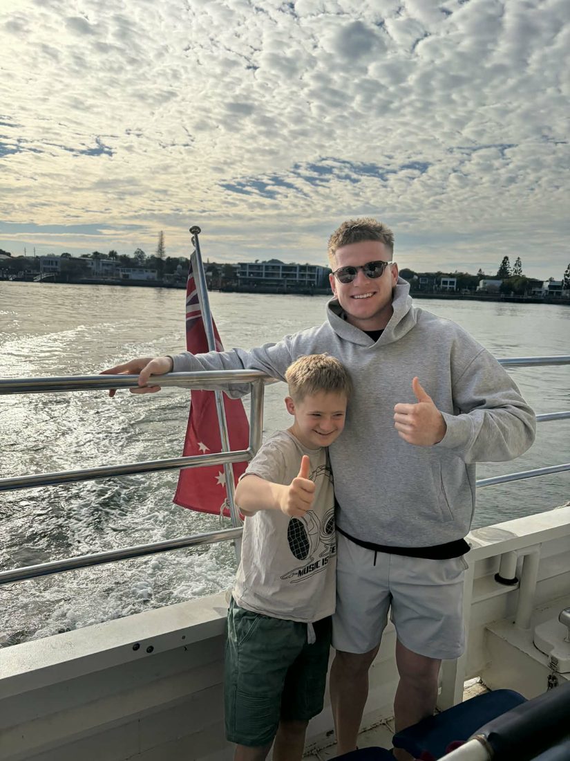 A support worker and participant giving thumbs up on a bay ferry