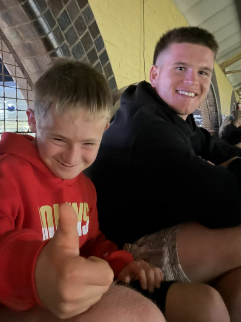 A support worker and participant laughing at the arcade